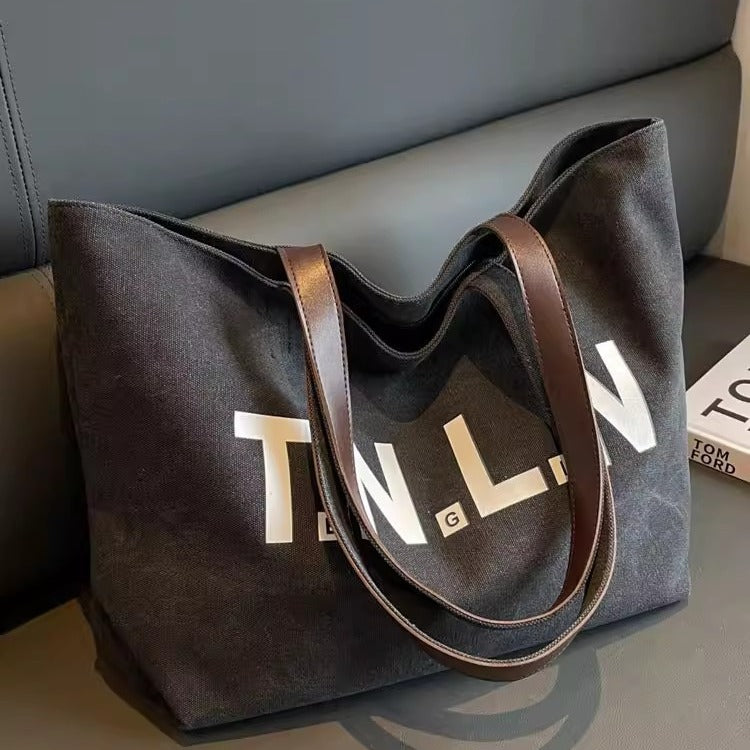 Large-capacity canvas shoulder tote bag.