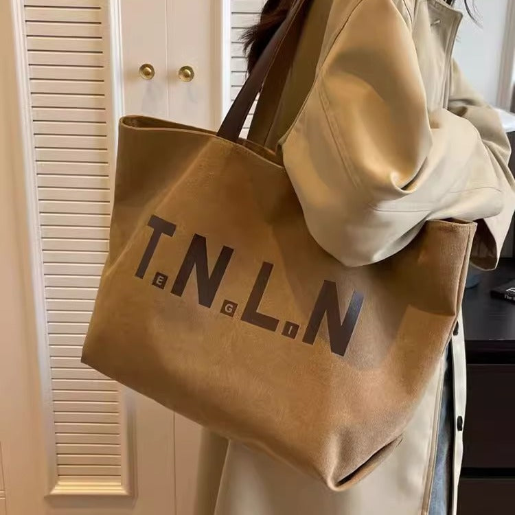 Large-capacity canvas shoulder tote bag.